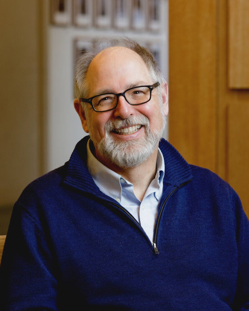A man, Andrew Mergen, in a dark blue sweater.