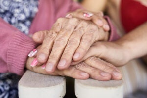 Hands of a young person and an older person.